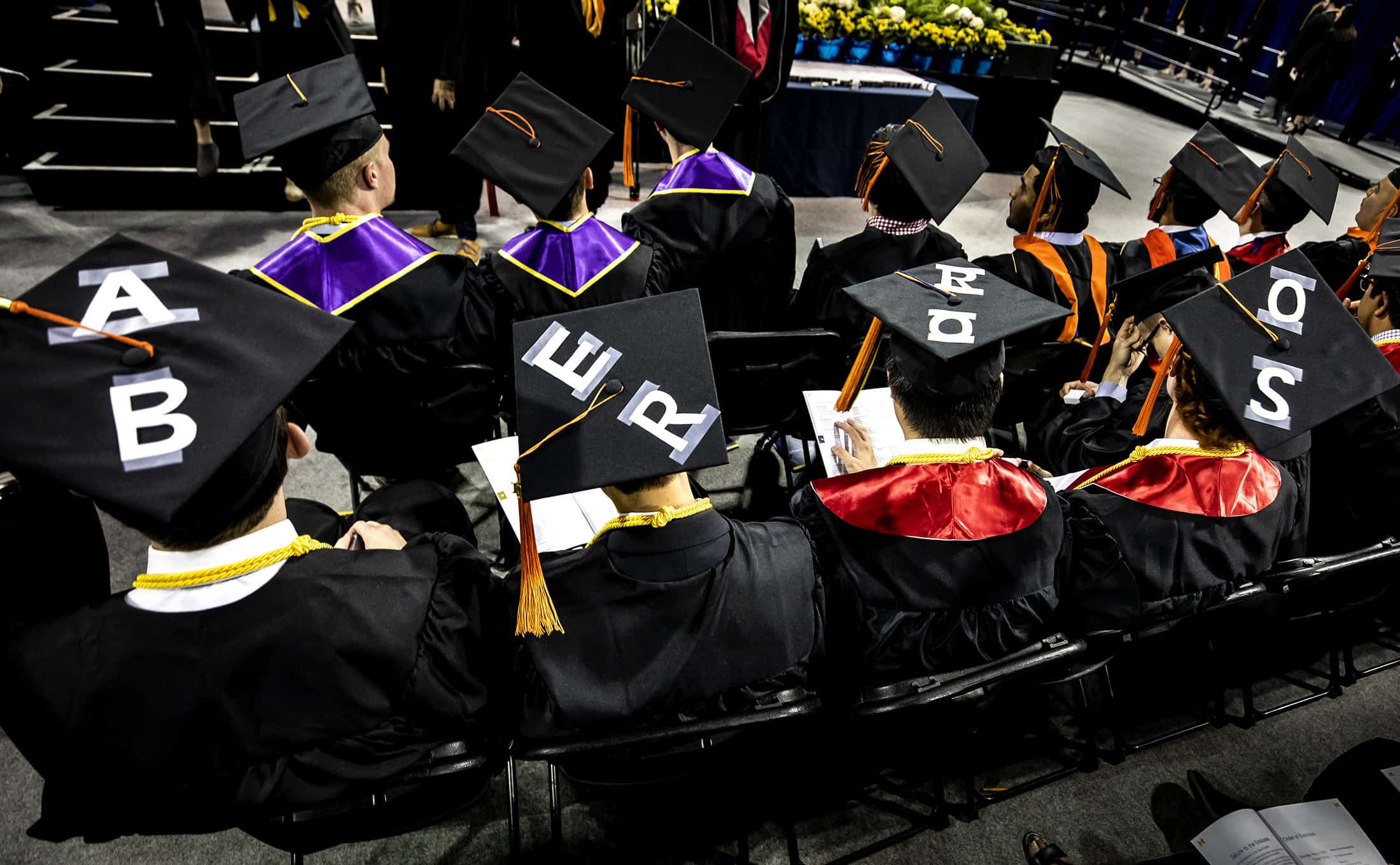 A group of graduating AERO students at commencement with their graduate caps