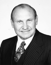 Headshot of Hans Weichsel Jr. wearing a suit and tie
